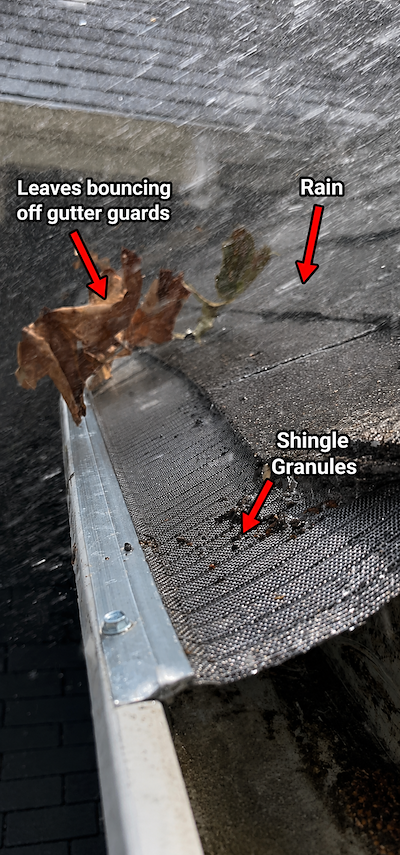 Rainwater flowing through micro-mesh gutter guard while leaves stay on top